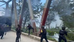 Aparat Brimob saat mencoba menebakan gas air mata untuk memisahkan dua kelompok masa yang bentrok (4)
